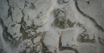Luxury Hotel Bar Areas: Natural Stone Design with Backlit Onyx and Exploded Travertine Applications
